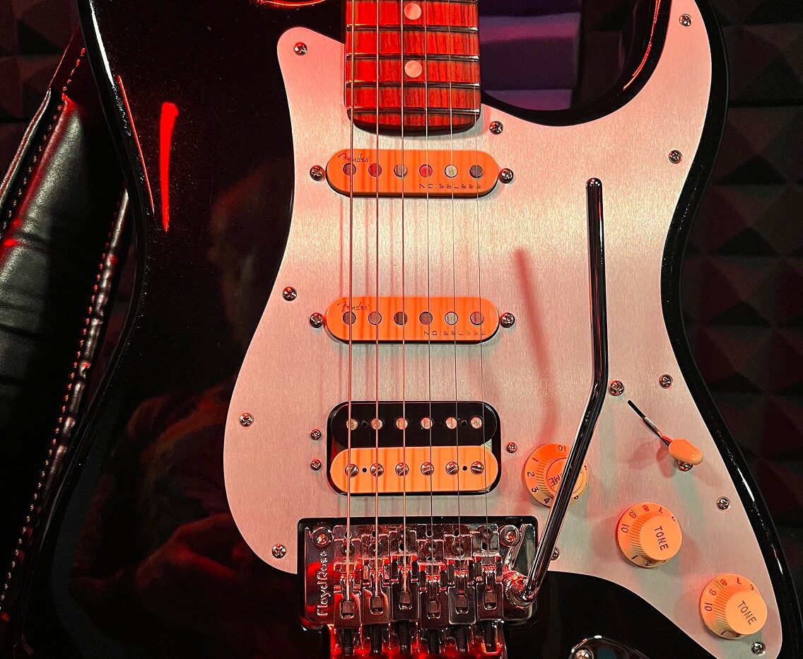 Electric guitar with red lighting details.