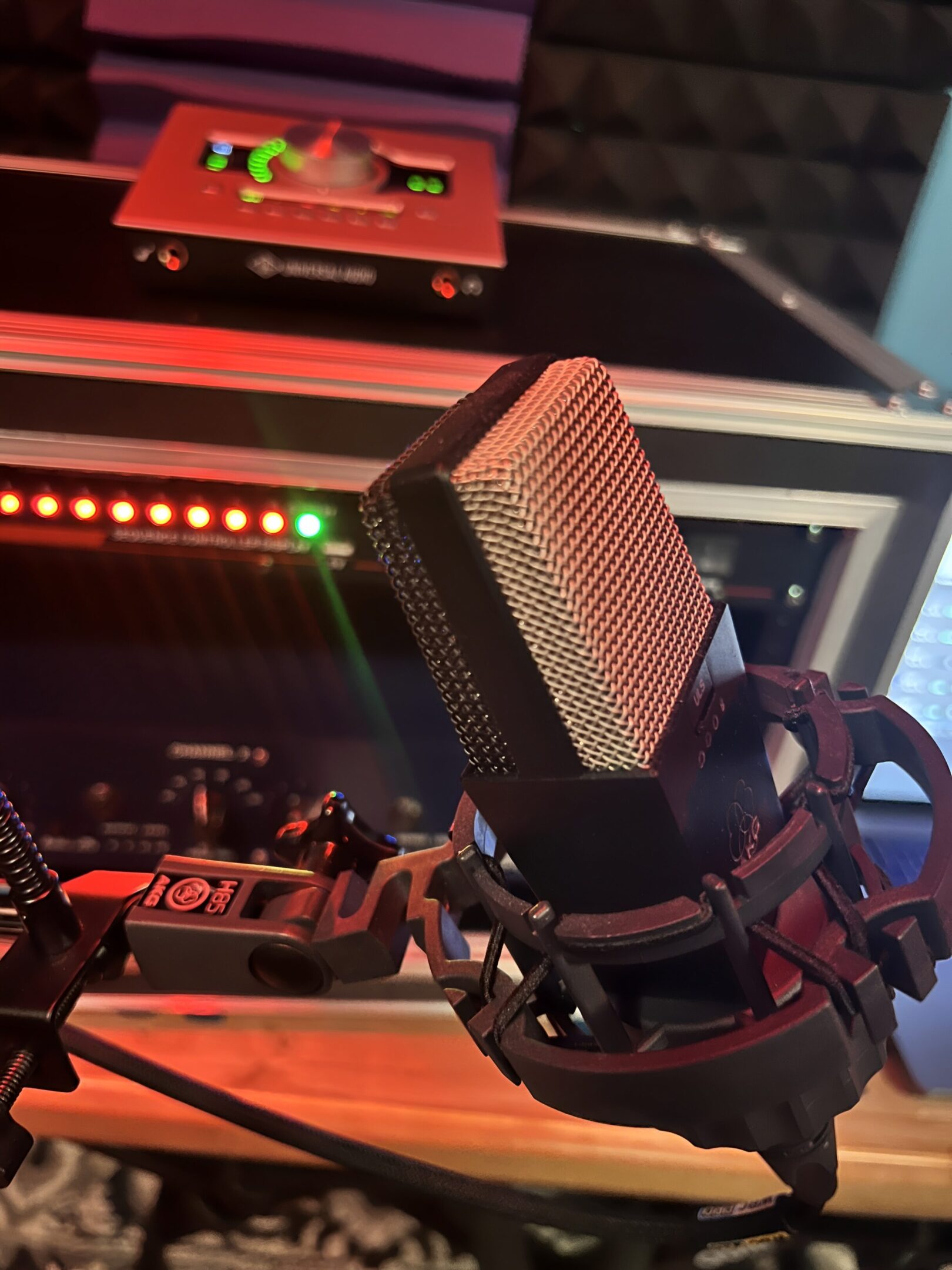 Studio microphone with audio equipment background.