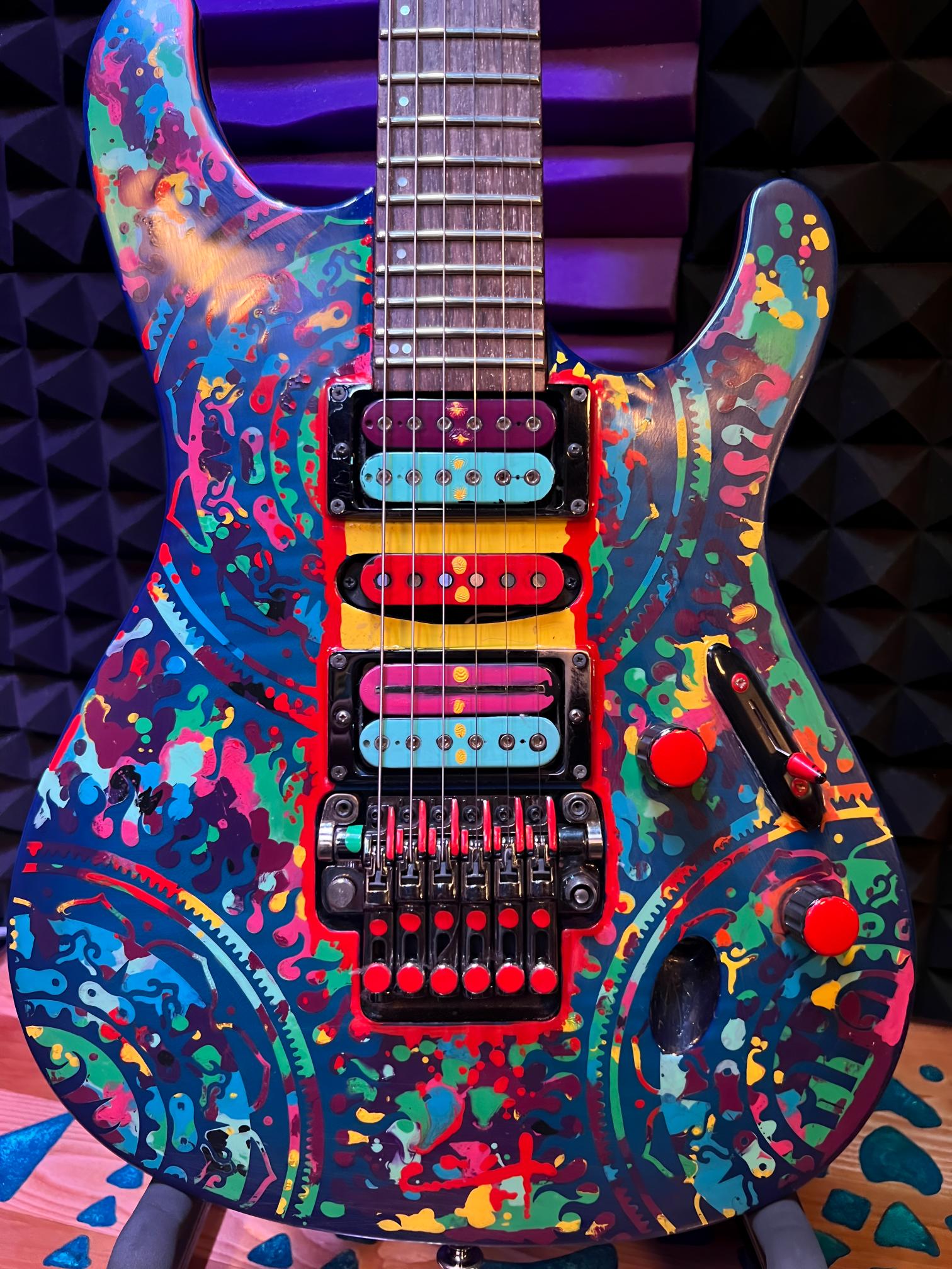 Colorful electric guitar with abstract patterns.