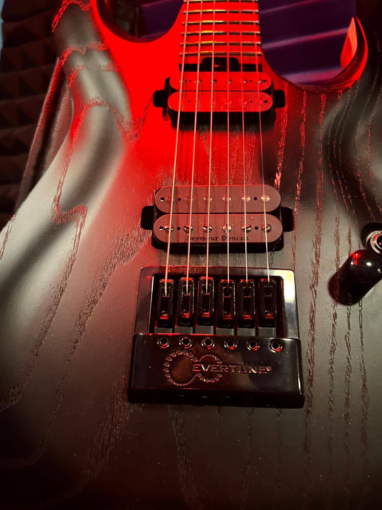 Electric guitar with red lighting details.