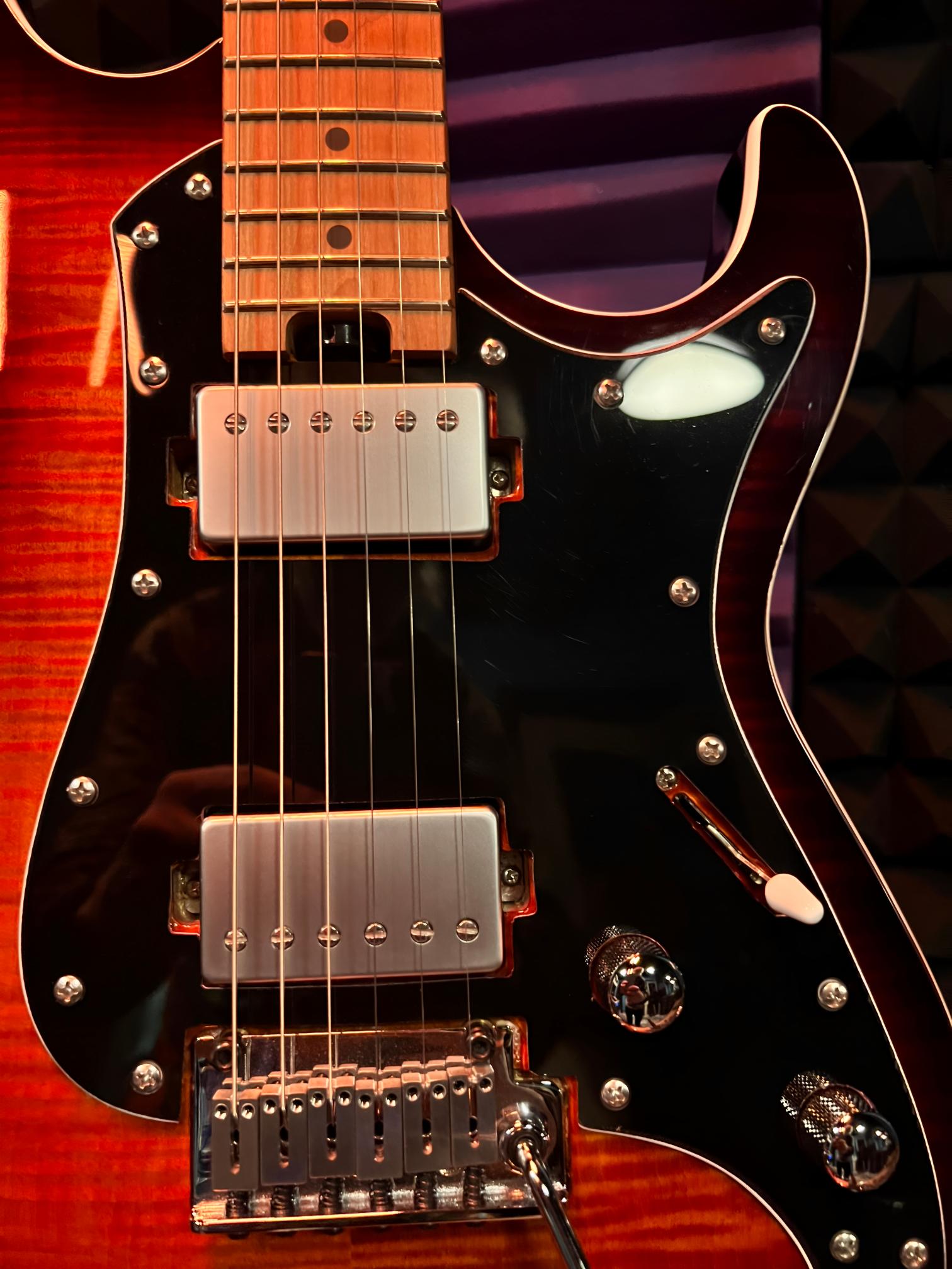 Electric guitar with sunburst finish and pickups.