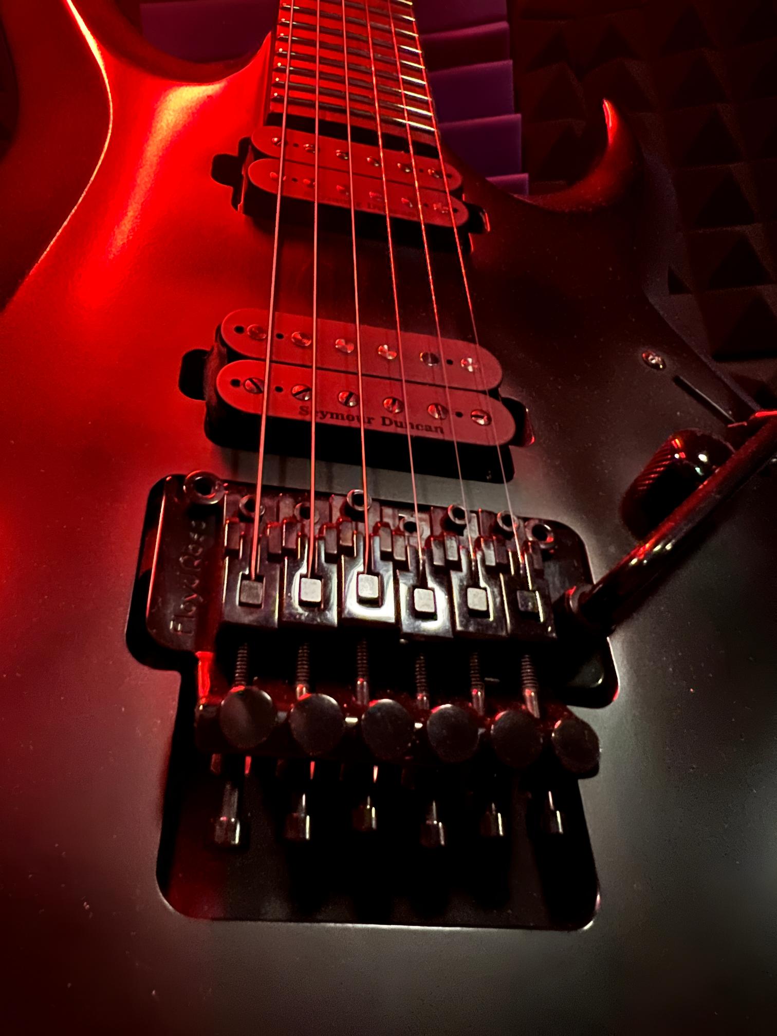 Electric guitar with red lighting details.