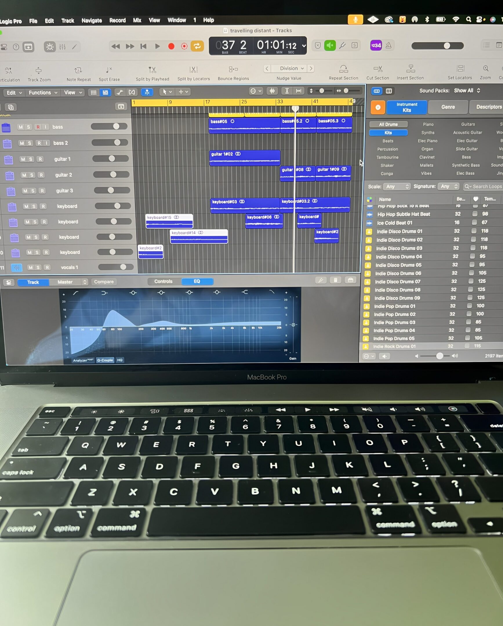 Laptop displaying music production software interface.