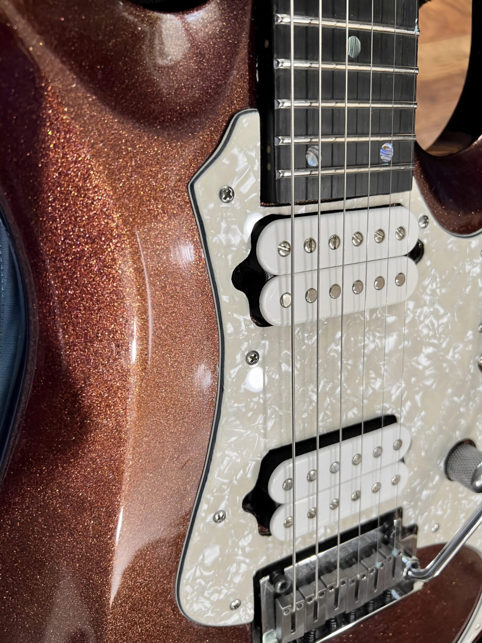 Metallic brown electric guitar with dual pickups.
