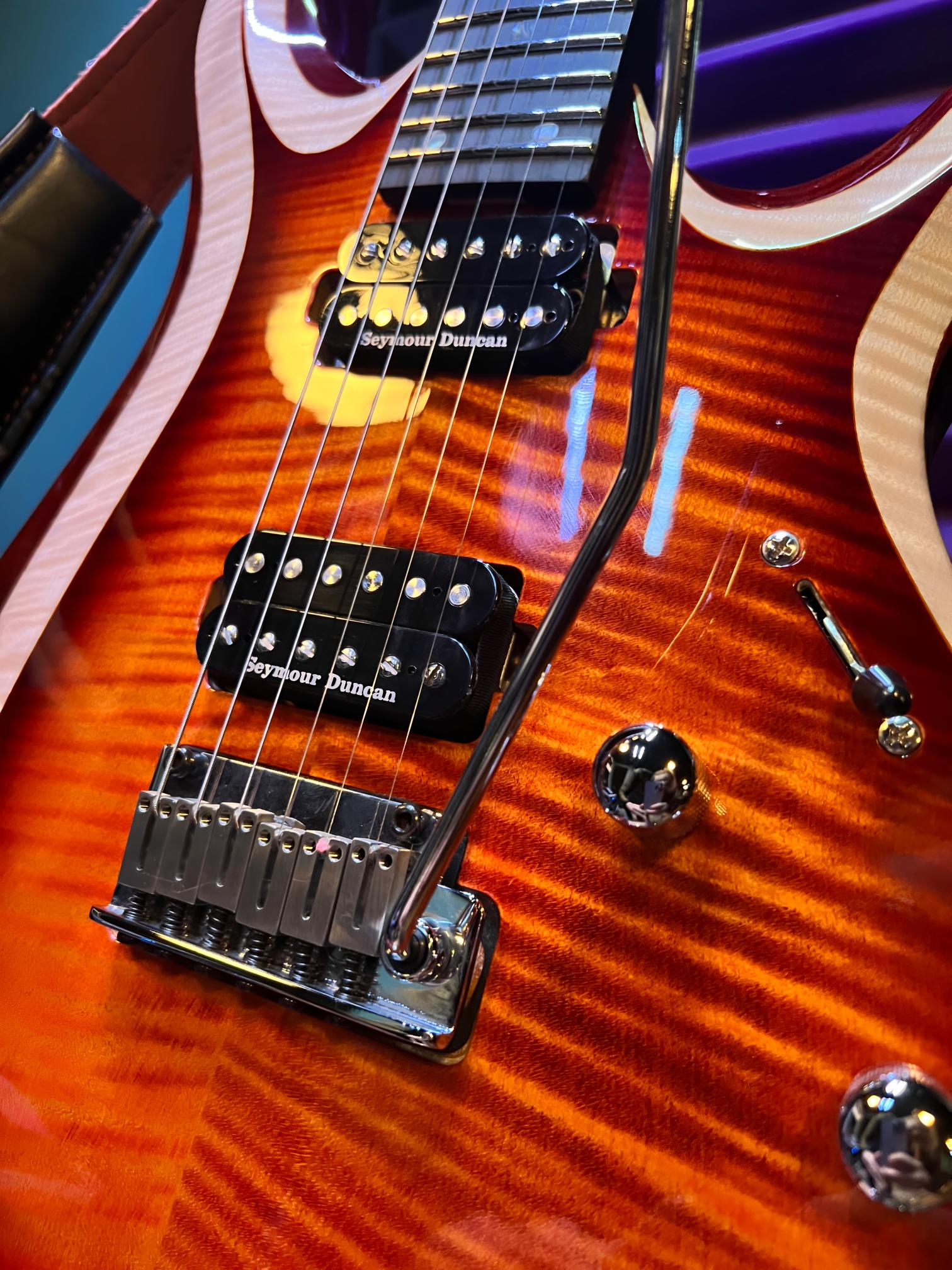 Electric guitar with vibrant orange finish.