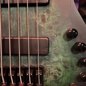 Electric guitar body with strings and knobs.