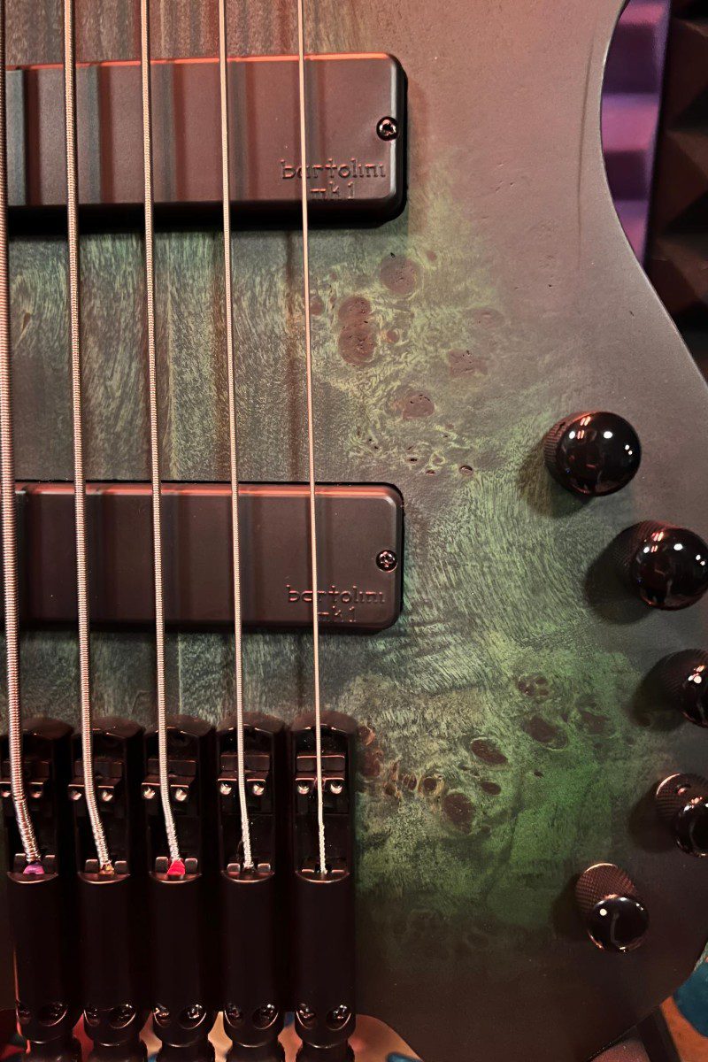 Electric guitar body with strings and knobs.