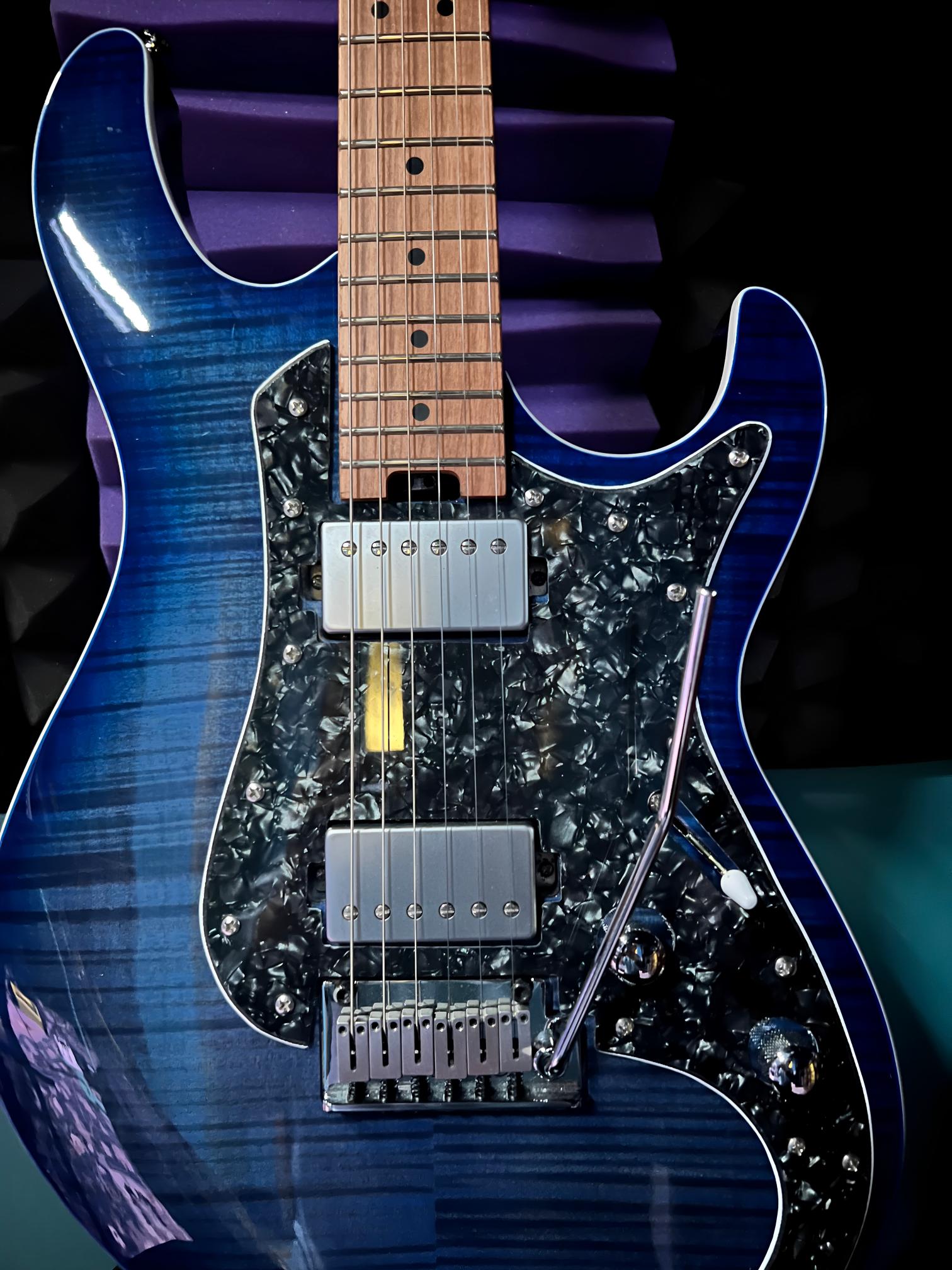 Blue electric guitar with wooden neck.